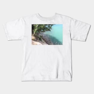 tree overhanging a rocky shore Kids T-Shirt